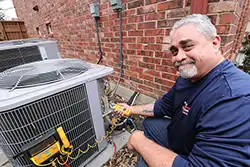 Extreme Comfort Air Conditioning & Heating Repair Technician installing new capacitor on AC Repair service call 