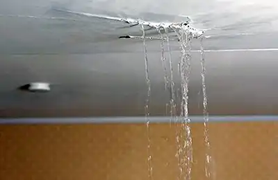Water leaking from ceiling from an AC system spitting water in attic