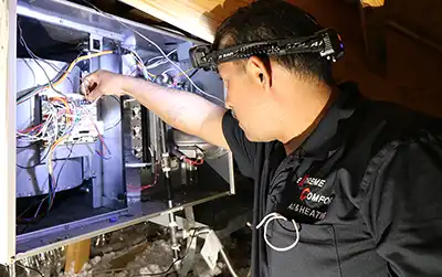 Extreme Comfort technicians repairing AC furnace in Dallas, TX attic