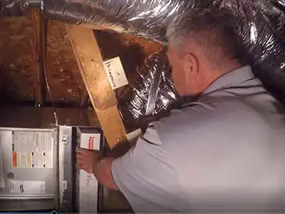 Furnace repair dallas by hvac technician changing air filter in furnace