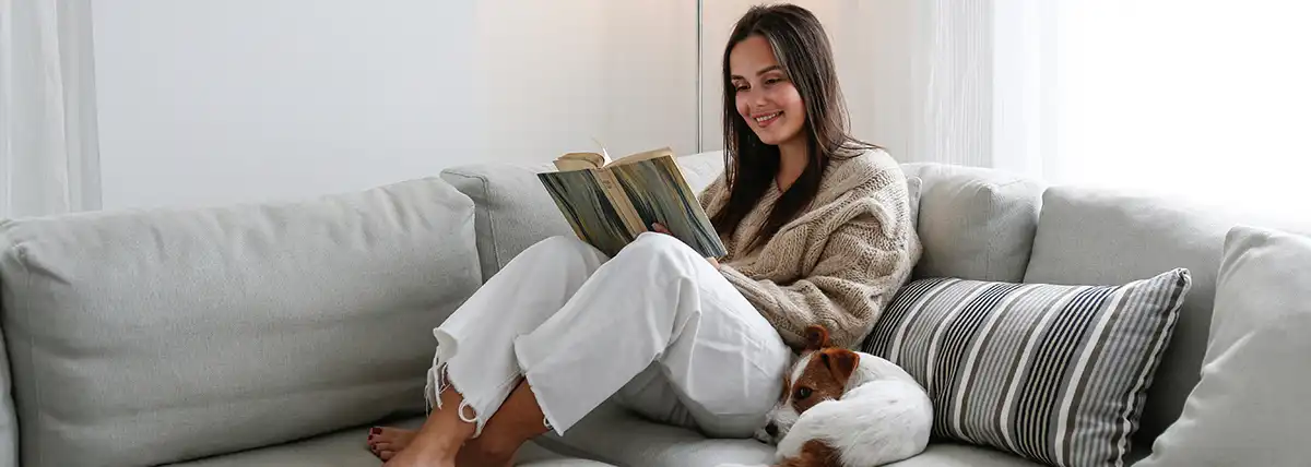 warm woman on sofa from furnace installation in Dallas